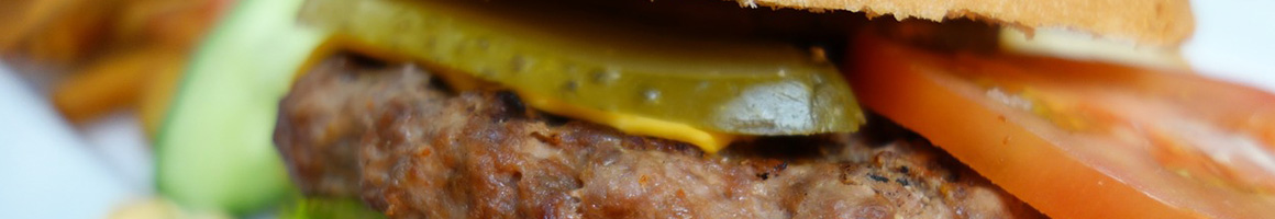 Eating American (Traditional) Burger Hot Dog at Riley's Hot Dog & Burger Gourmet restaurant in New Britain, CT.